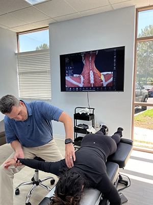 Chiropractor Irvine CA Nicholas Hoy With Patients Arm